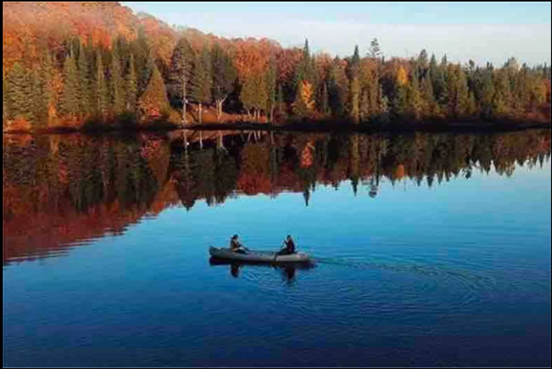 Canoeing on the lake in fall foliage