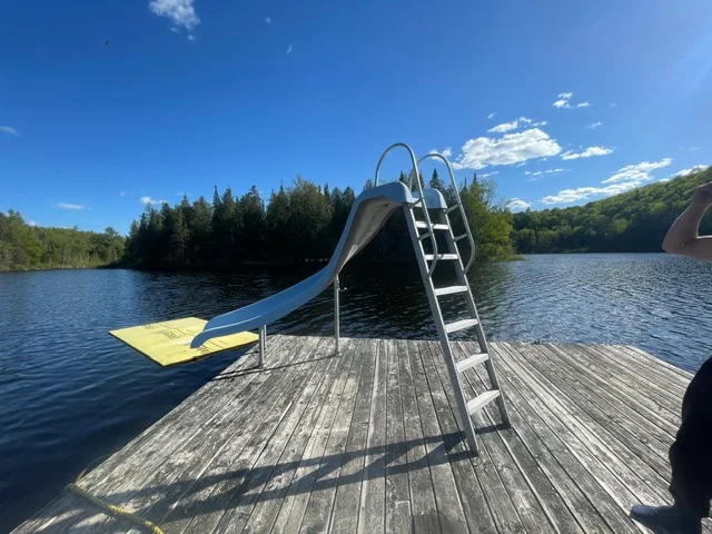 Floating dock with slide on the lake